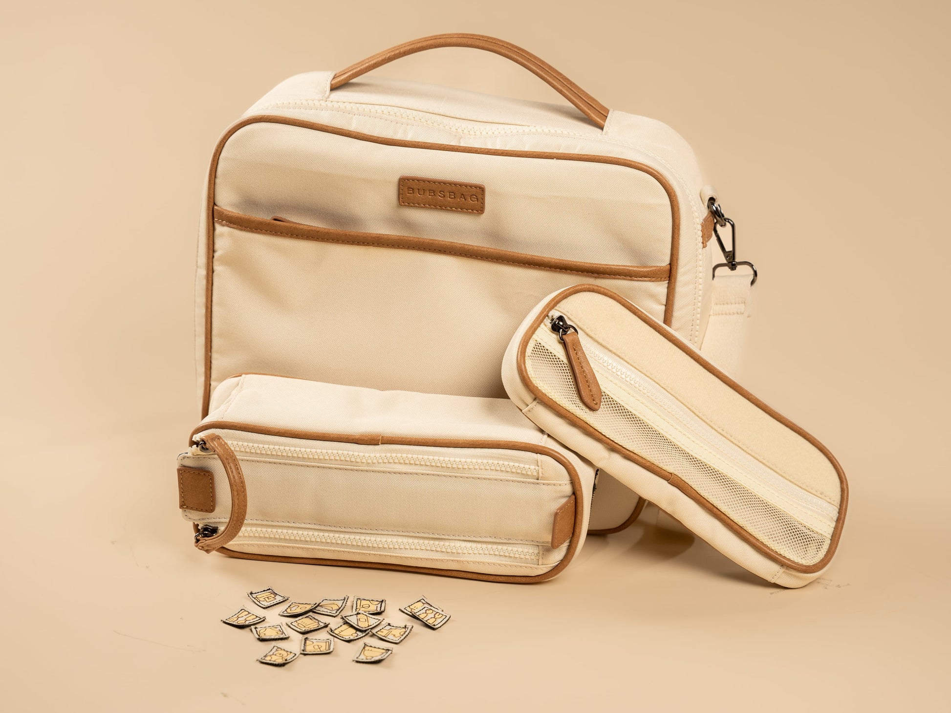 Organized beige nappy bag with removable dividers and labeled compartments
