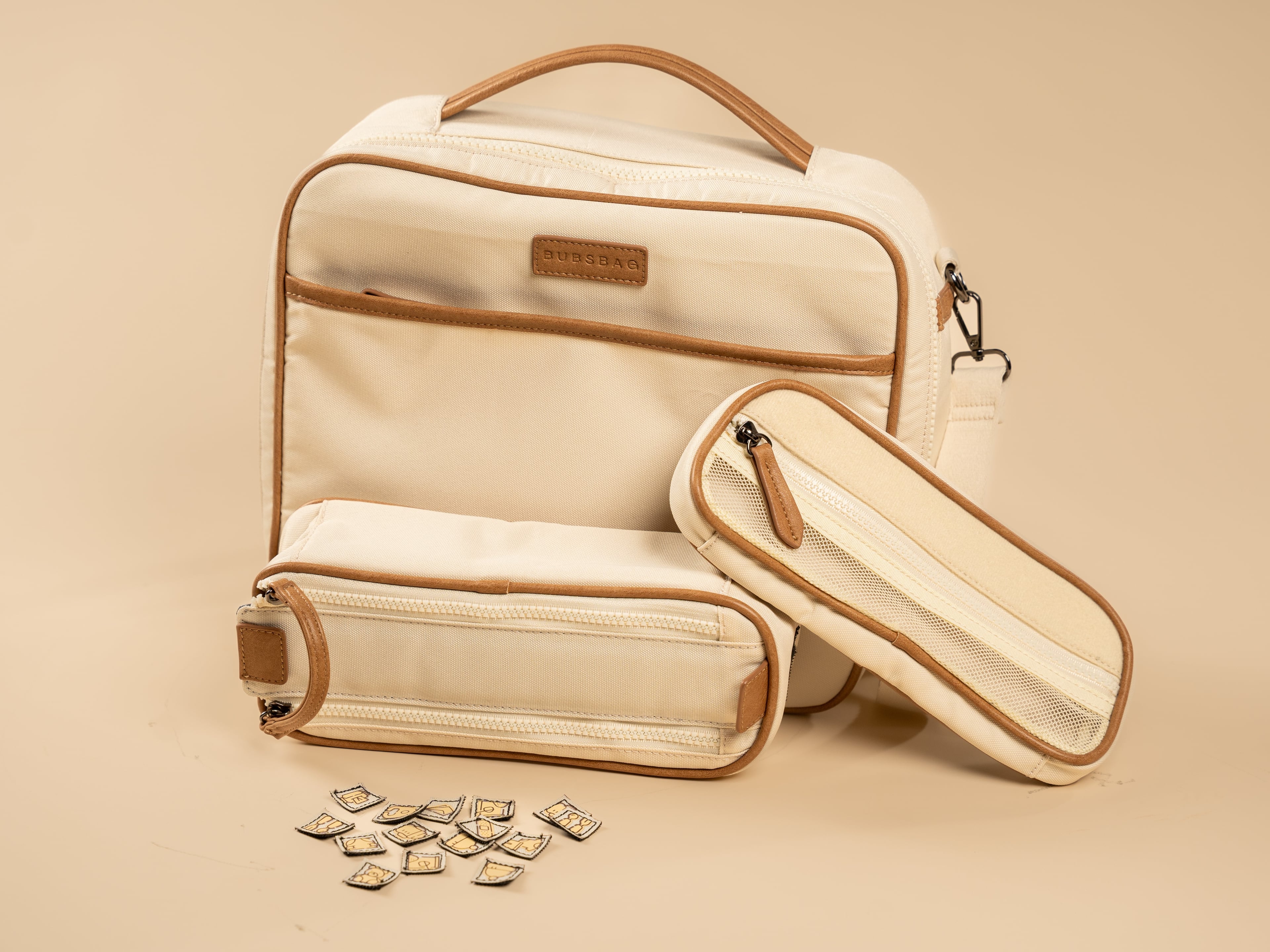 Organized beige nappy bag with removable dividers and labeled compartments