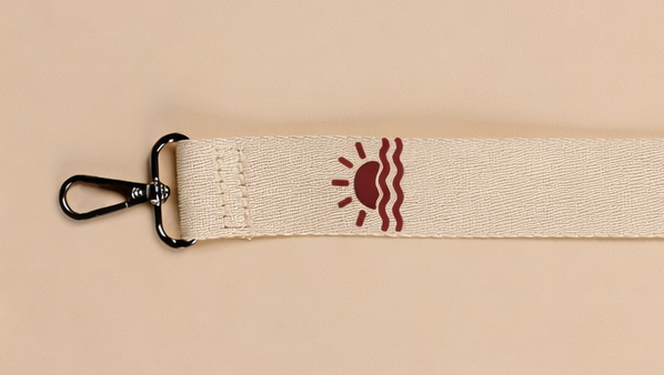 Personalized diaper bag strap with embroidered sun icon